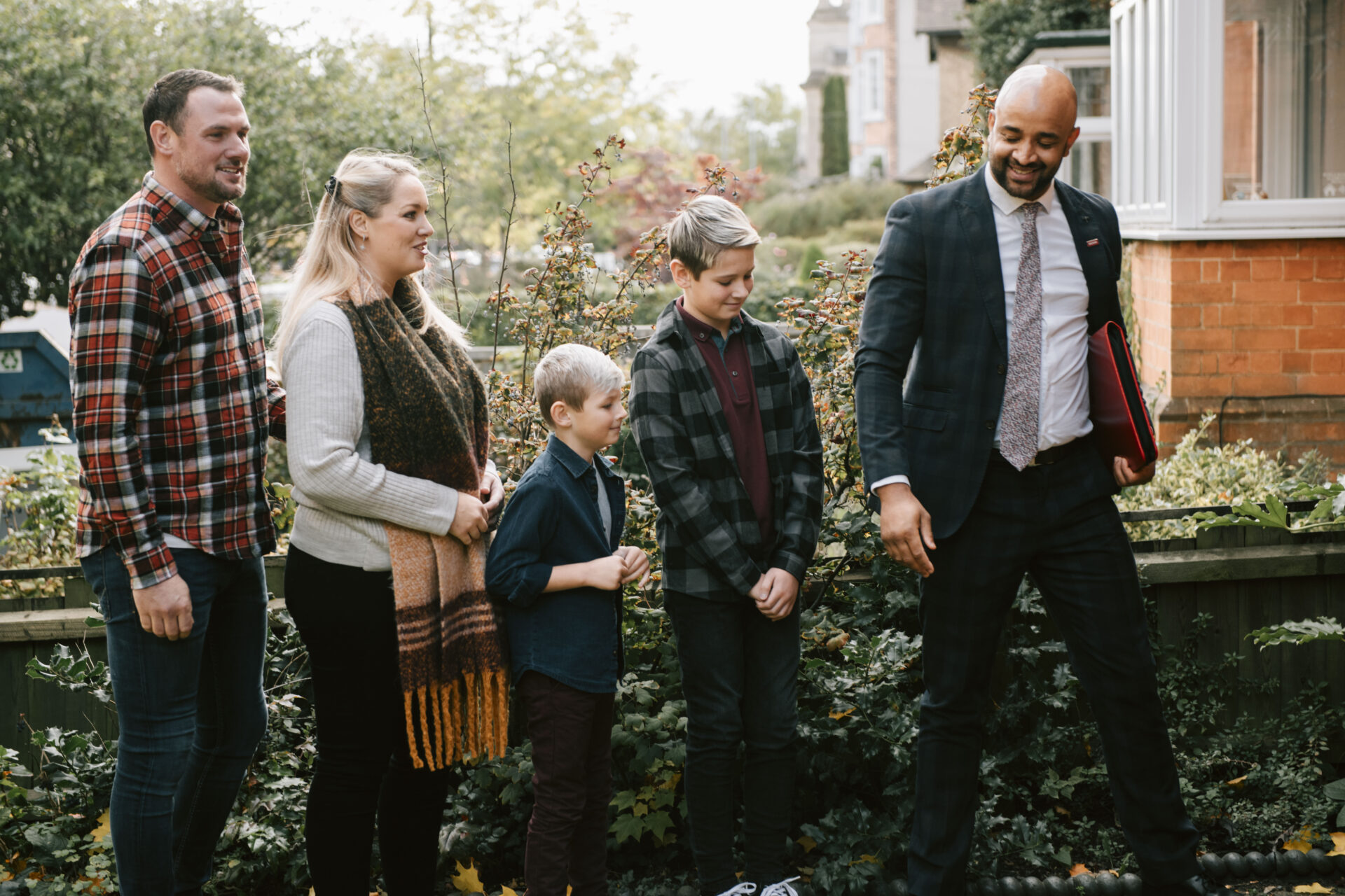 a family viewing a house with an estate agent